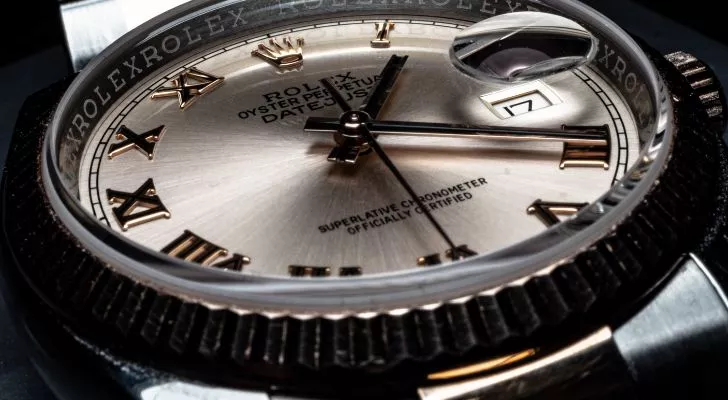 A close-up of a Rolex watch, featuring the Rolex logo in place of the number 12